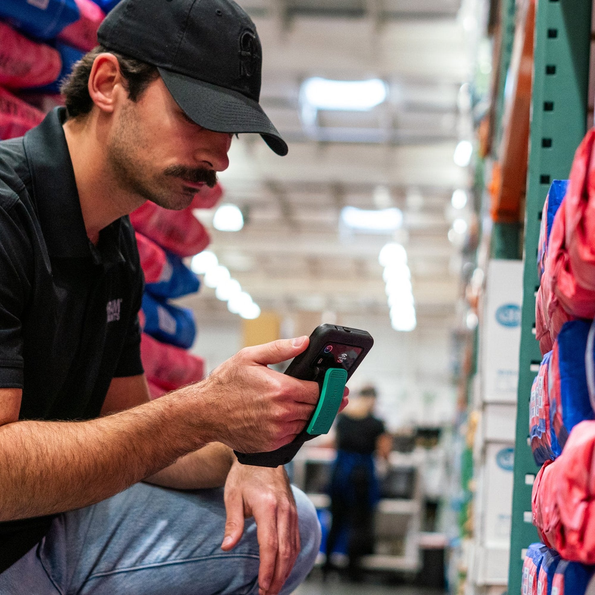 Worker using Zebra handheld computer protected by IntelliSkin rugged case