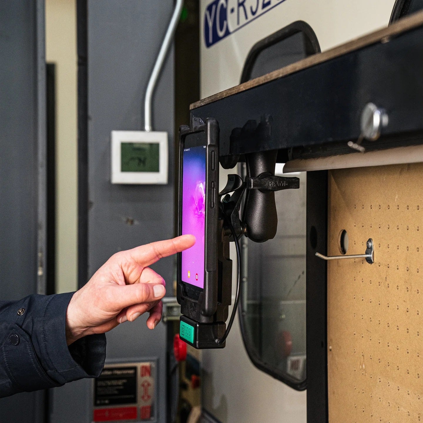 RAM Tough-Mag magnetic mount securing a tablet computer on warehouse equipment