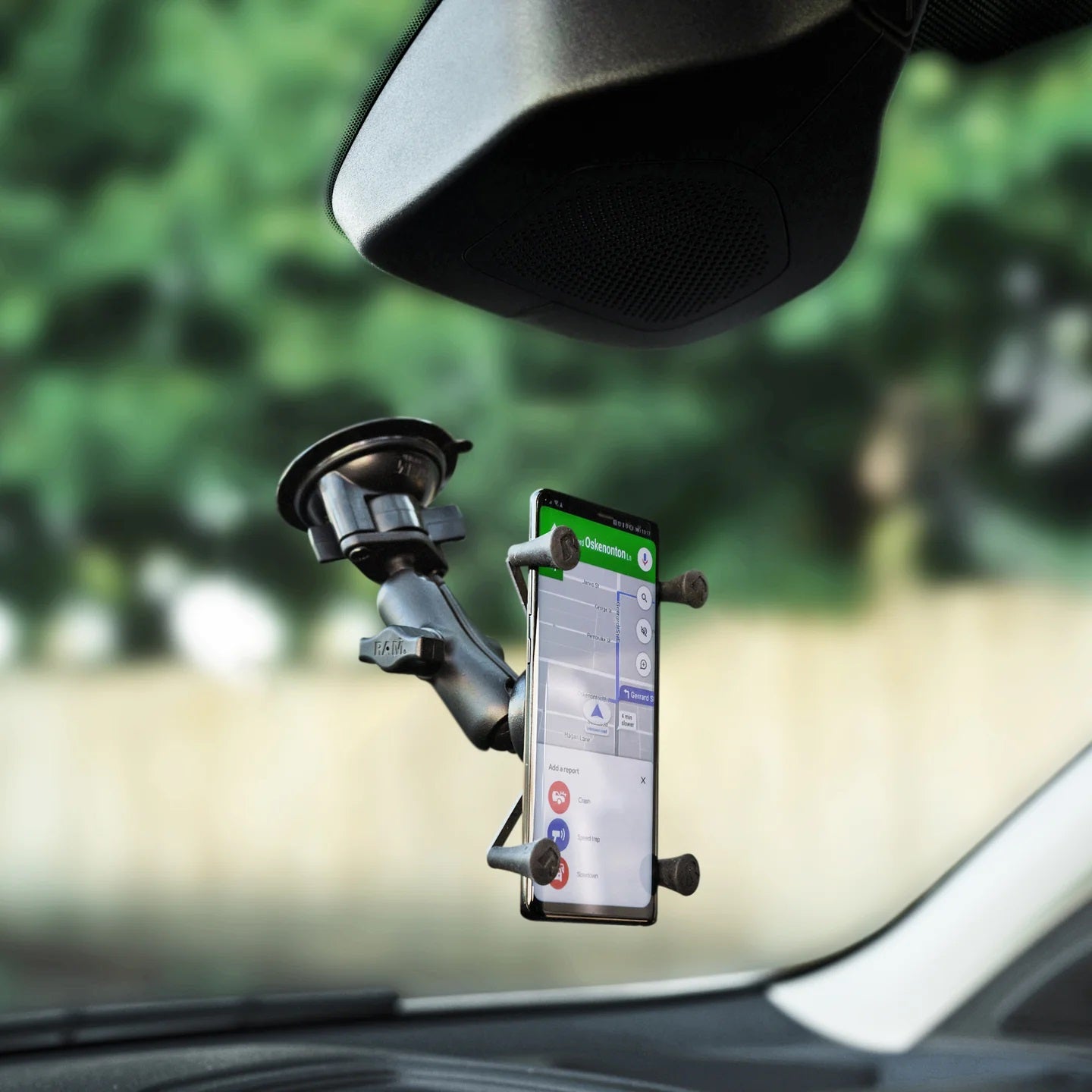 Side view of rugged X-Grip phone holder on vehicle windshield