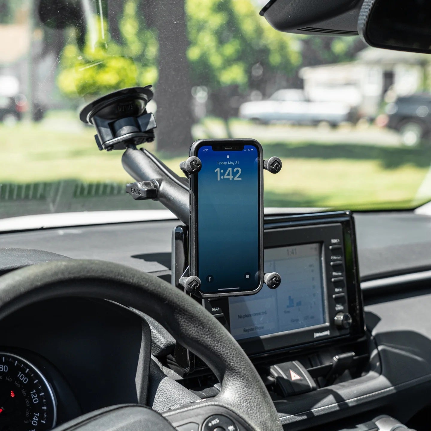 Phone mounted on a car windshield with a smartphone displaying the time